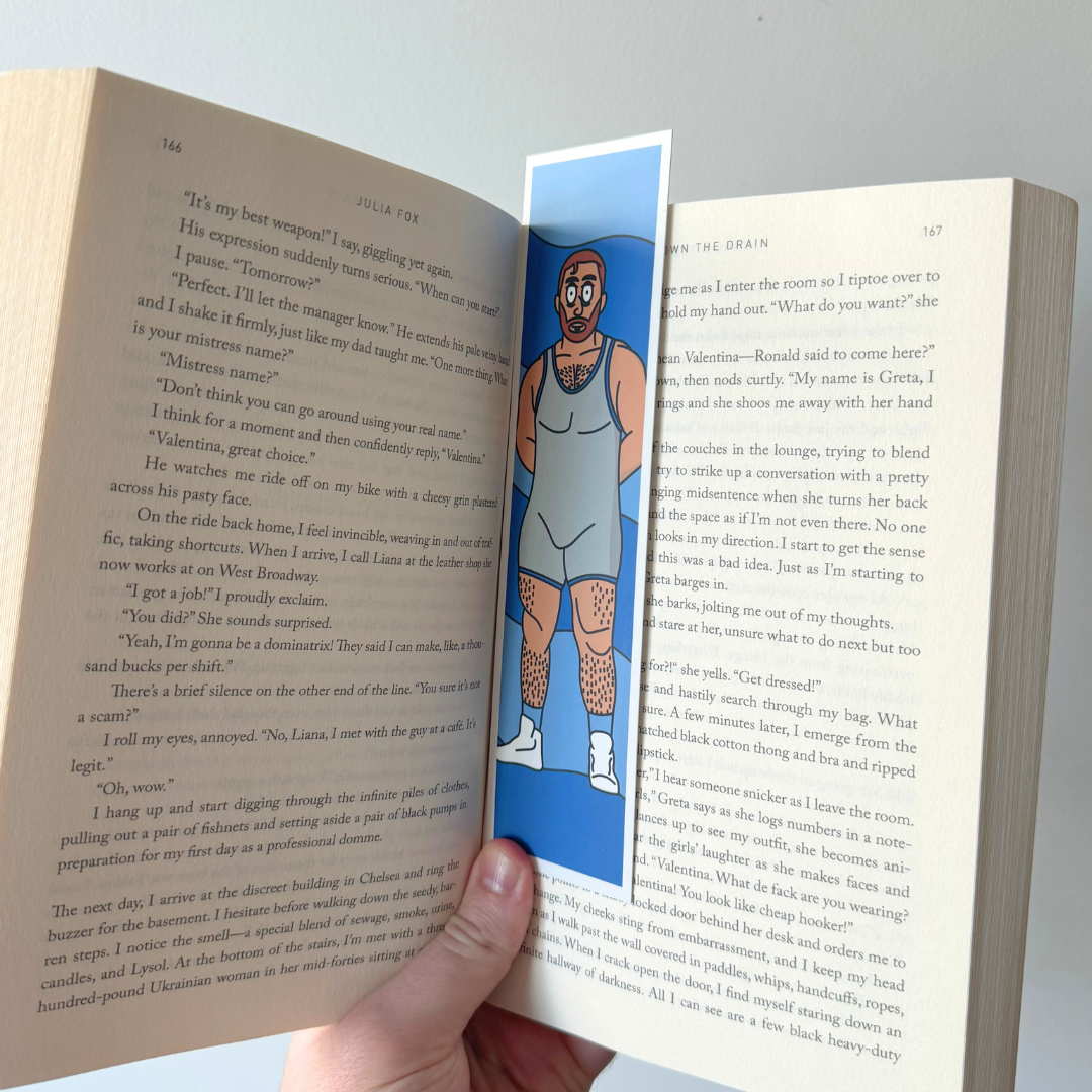 A bookmark in a book, with a cartoonish character in a grey wrestling suit on a blue background.